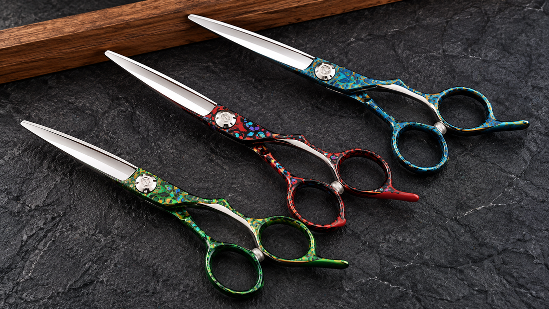 Colorful professional cutting shears on a dark textured barber workstation