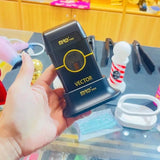 MRD Pro Vector foil shaver in black held in hand in a barbershop